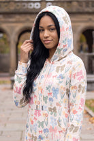 Nuggles® Hoodie Dress in Garden Party worn with the hood up, bow and floral print on cream