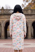 Nuggles® Hoodie Dress in Garden Party, back view with the hood down over its cream lining