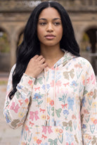 Nuggles® Hoodie Dress in Garden Party, waist-up crop showing the cream drawstring and print detail