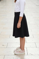 Model wearing Nuggles®  Girl's Athleisure Skirt in Black