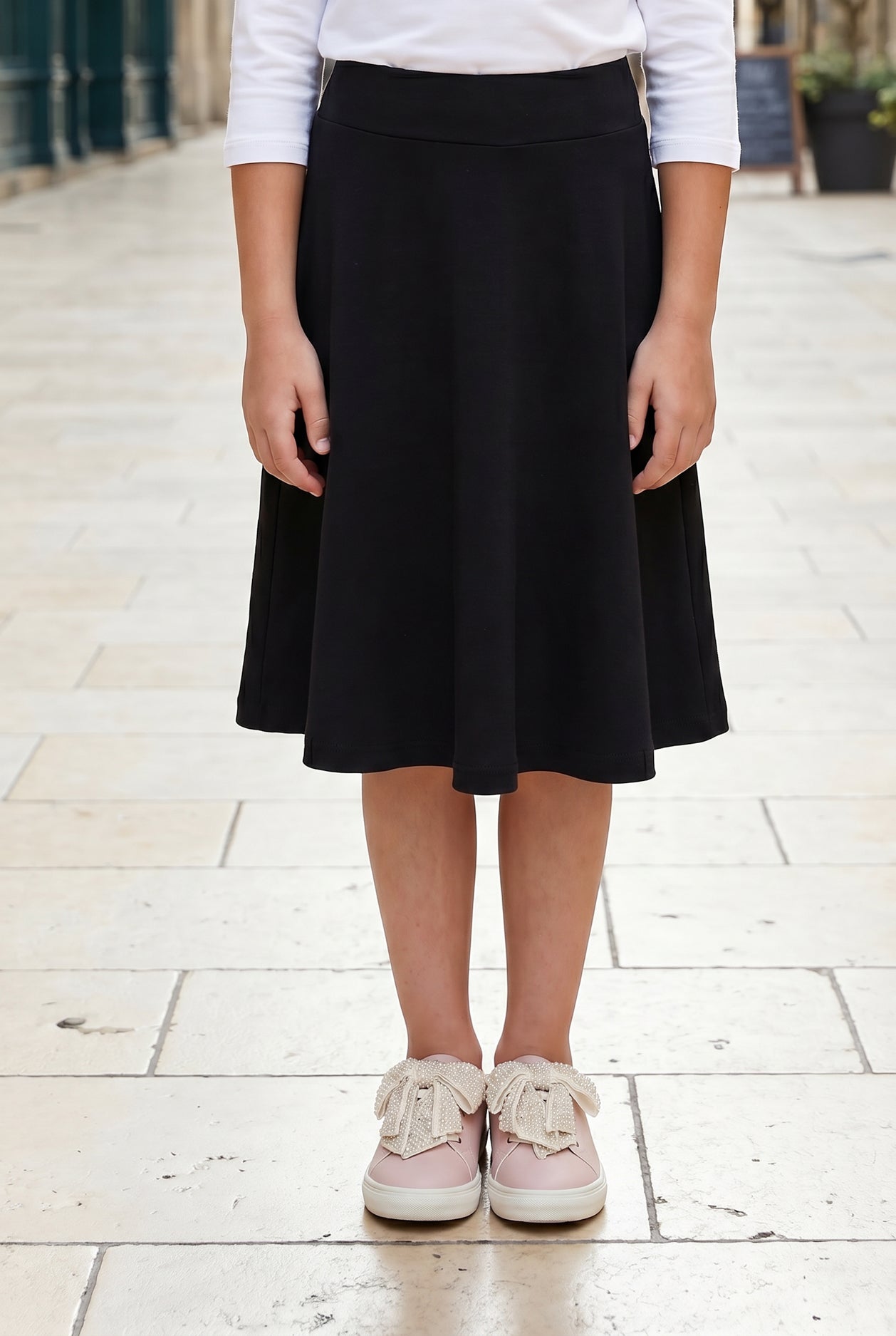 Model wearing Nuggles®  Girl's Athleisure Skirt in Black