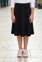 Model wearing Nuggles®  Girl's Athleisure Skirt in Black
