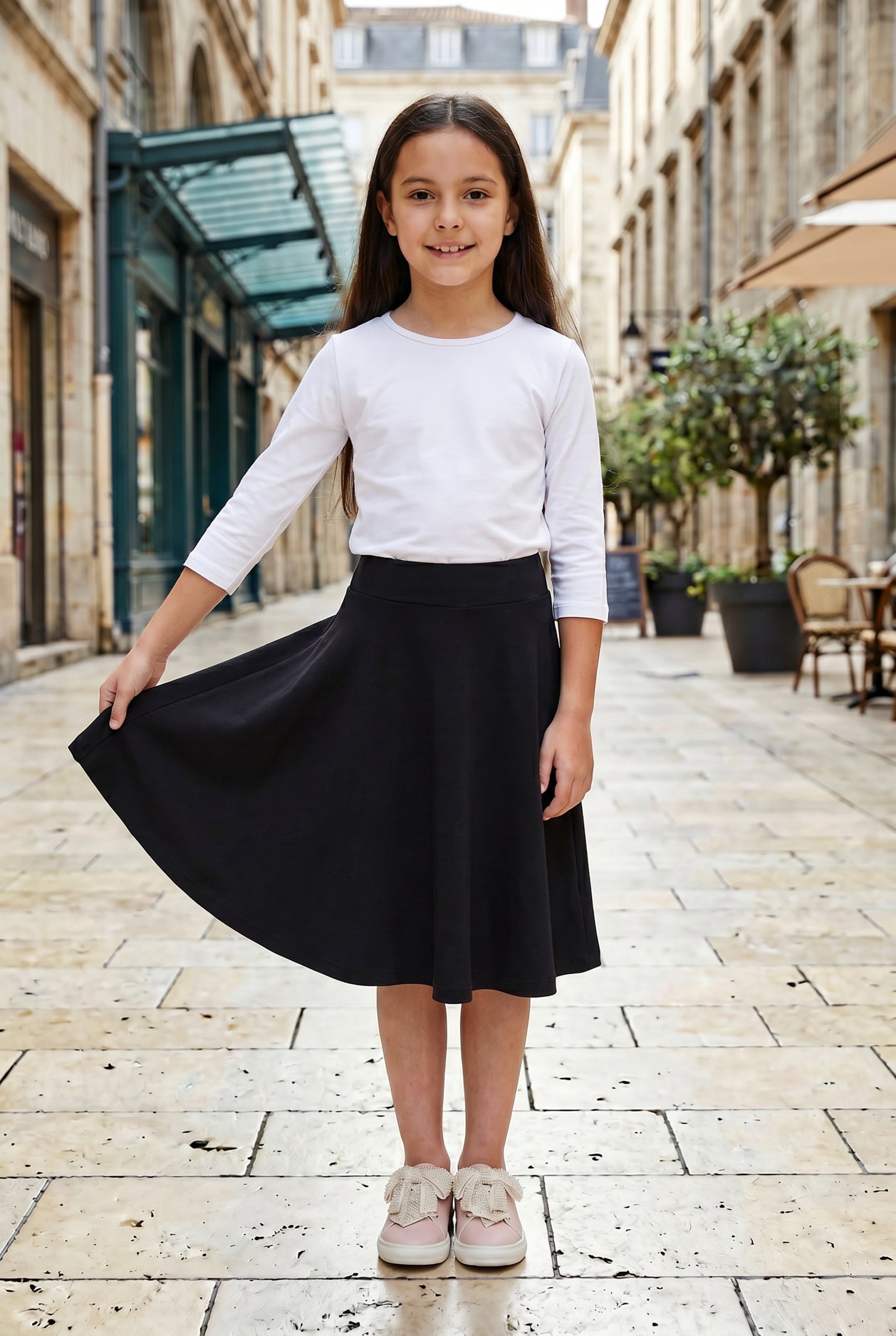 Model wearing Nuggles®  Girl's Athleisure Skirt in Black