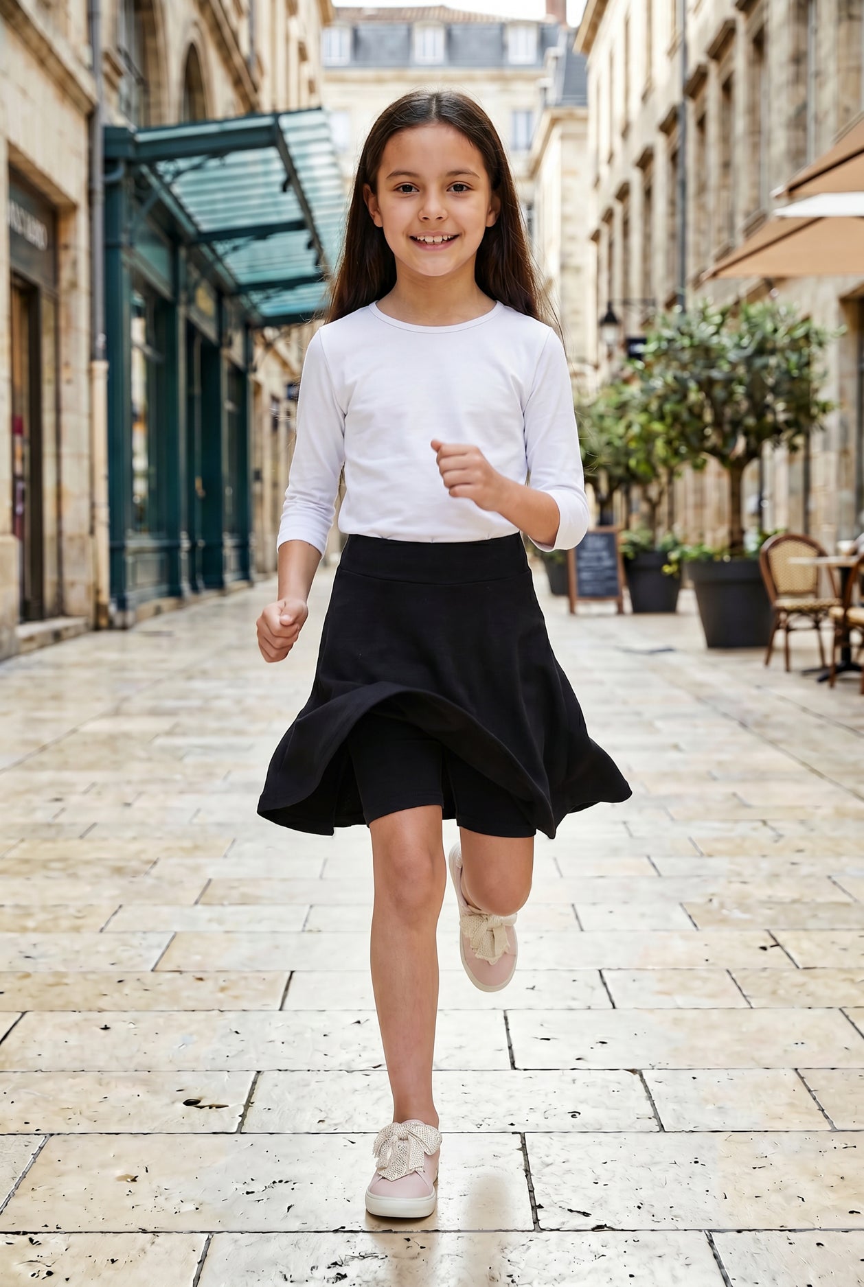 Model wearing Nuggles®  Girl's Athleisure Skirt in Black