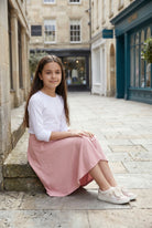 Model wearing Nuggles®  Girl's Athleisure Skirt in Dusty Pink