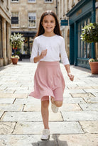 Model wearing Nuggles®  Girl's Athleisure Skirt in Dusty Pink