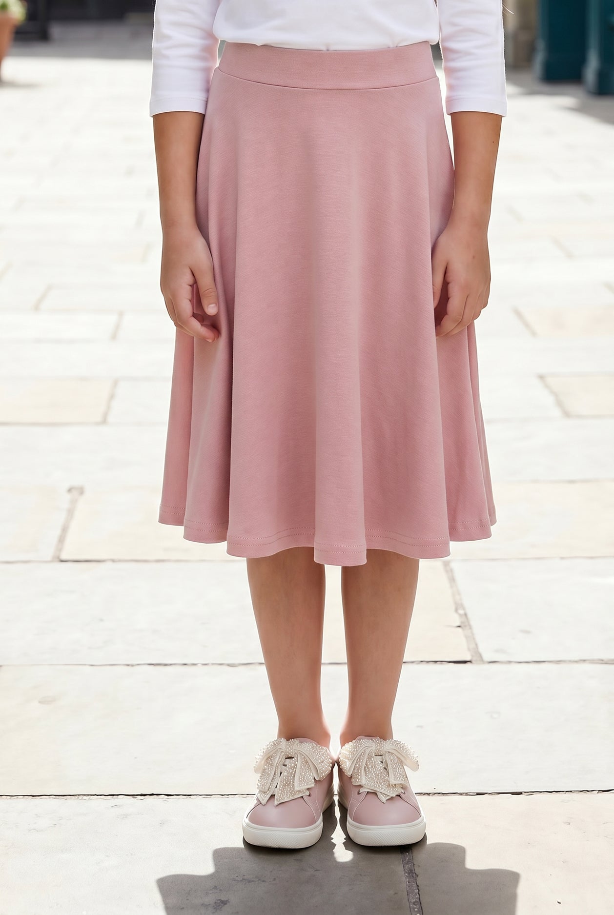 Model wearing Nuggles®  Girl's Athleisure Skirt in Dusty Pink