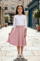 Model wearing Nuggles®  Girl's Athleisure Skirt in Dusty Pink