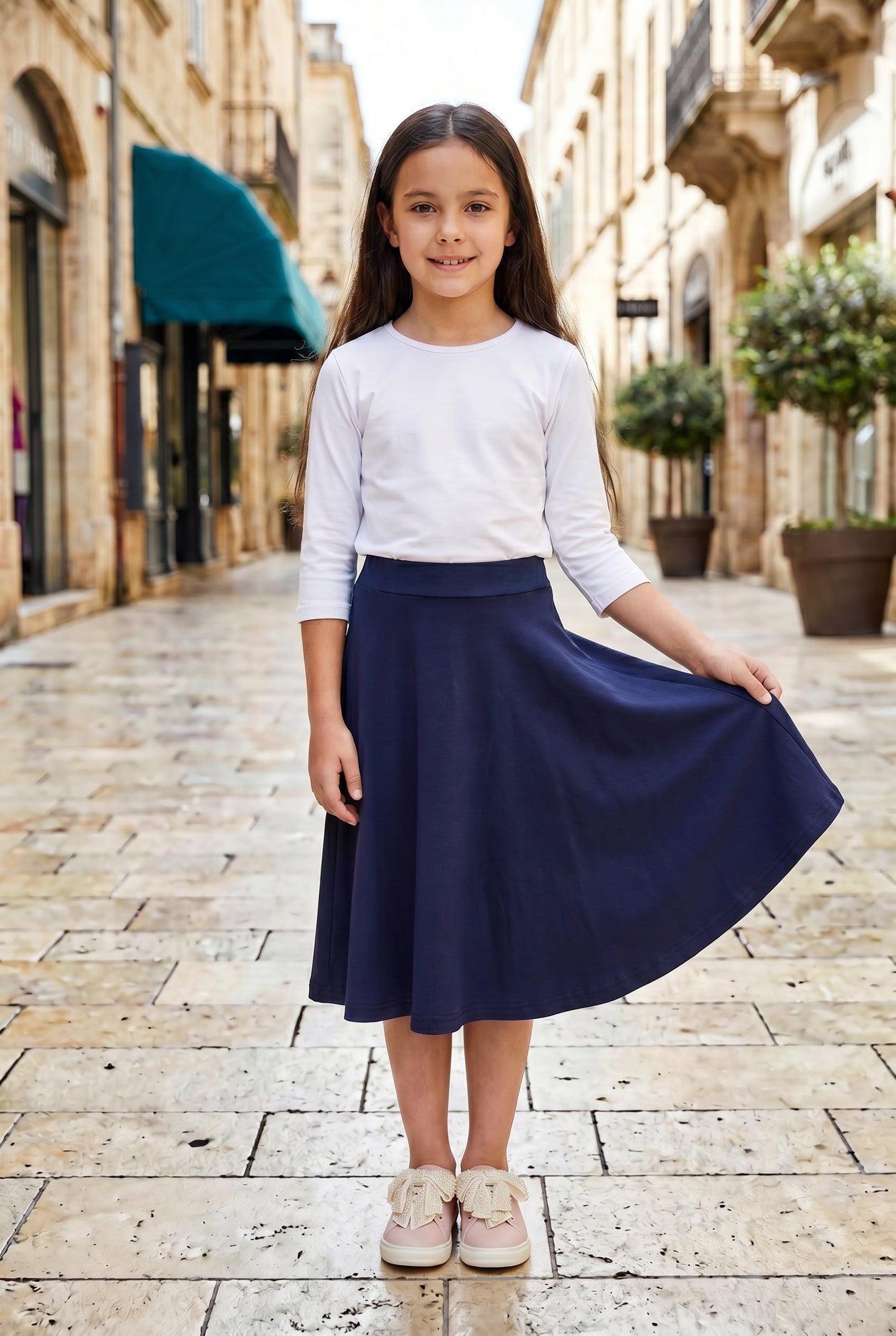 Model wearing Nuggles®  Girl's Athleisure Skirt in Navy