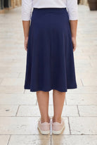Model wearing Nuggles®  Girl's Athleisure Skirt in Navy