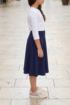 Model wearing Nuggles®  Girl's Athleisure Skirt in Navy