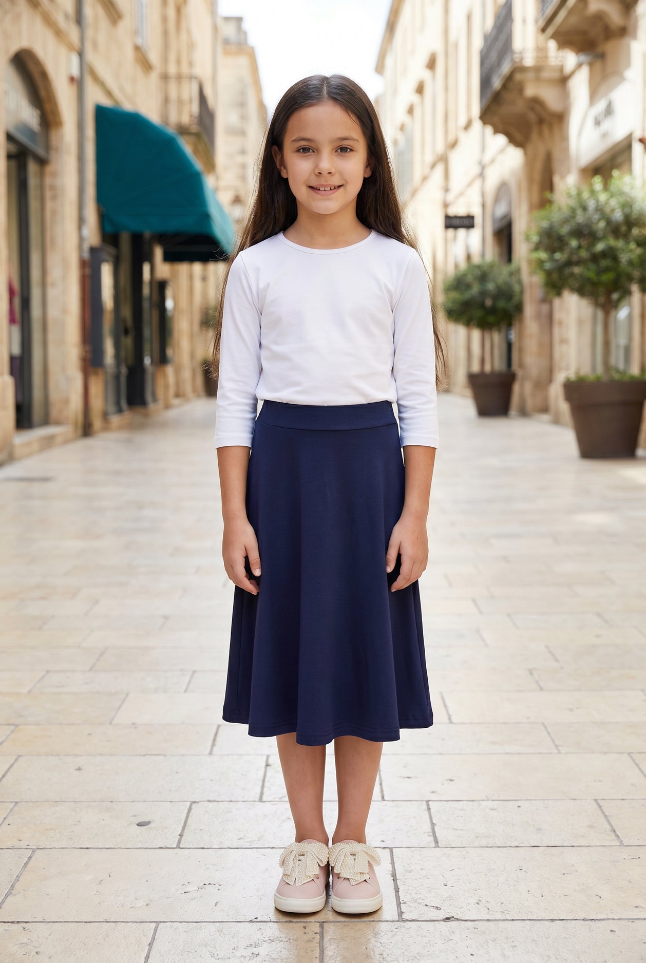 Model wearing Nuggles®  Girl's Athleisure Skirt in Navy