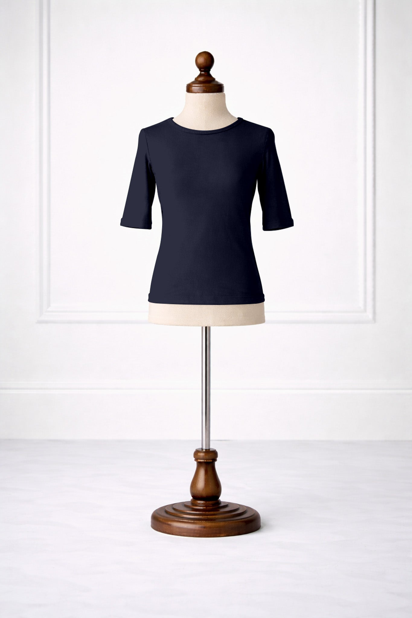 Navy blue shirt on a mannequin against a white background