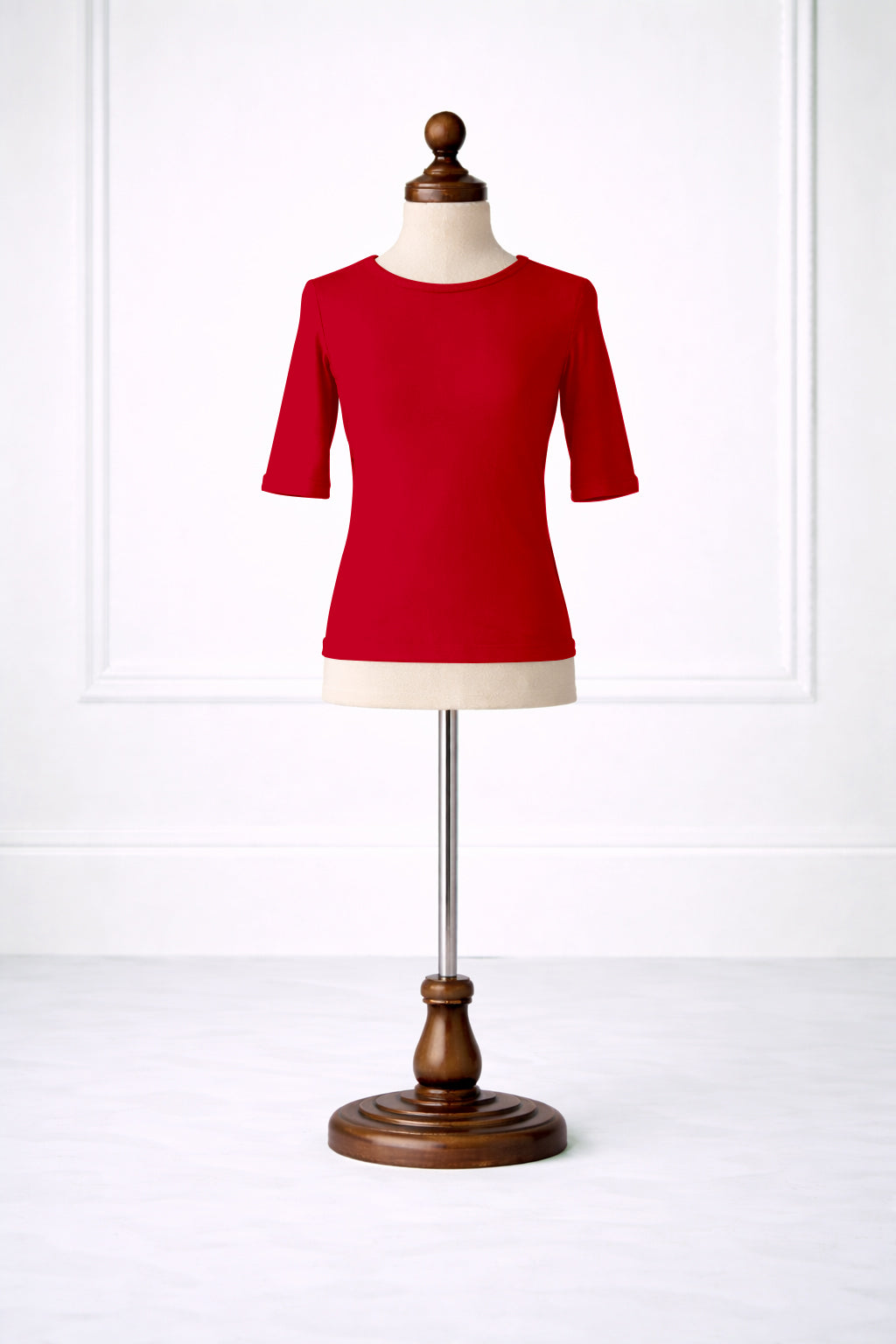 Red shirt on a mannequin against a white background