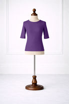 Purple shirt on a mannequin against a white background