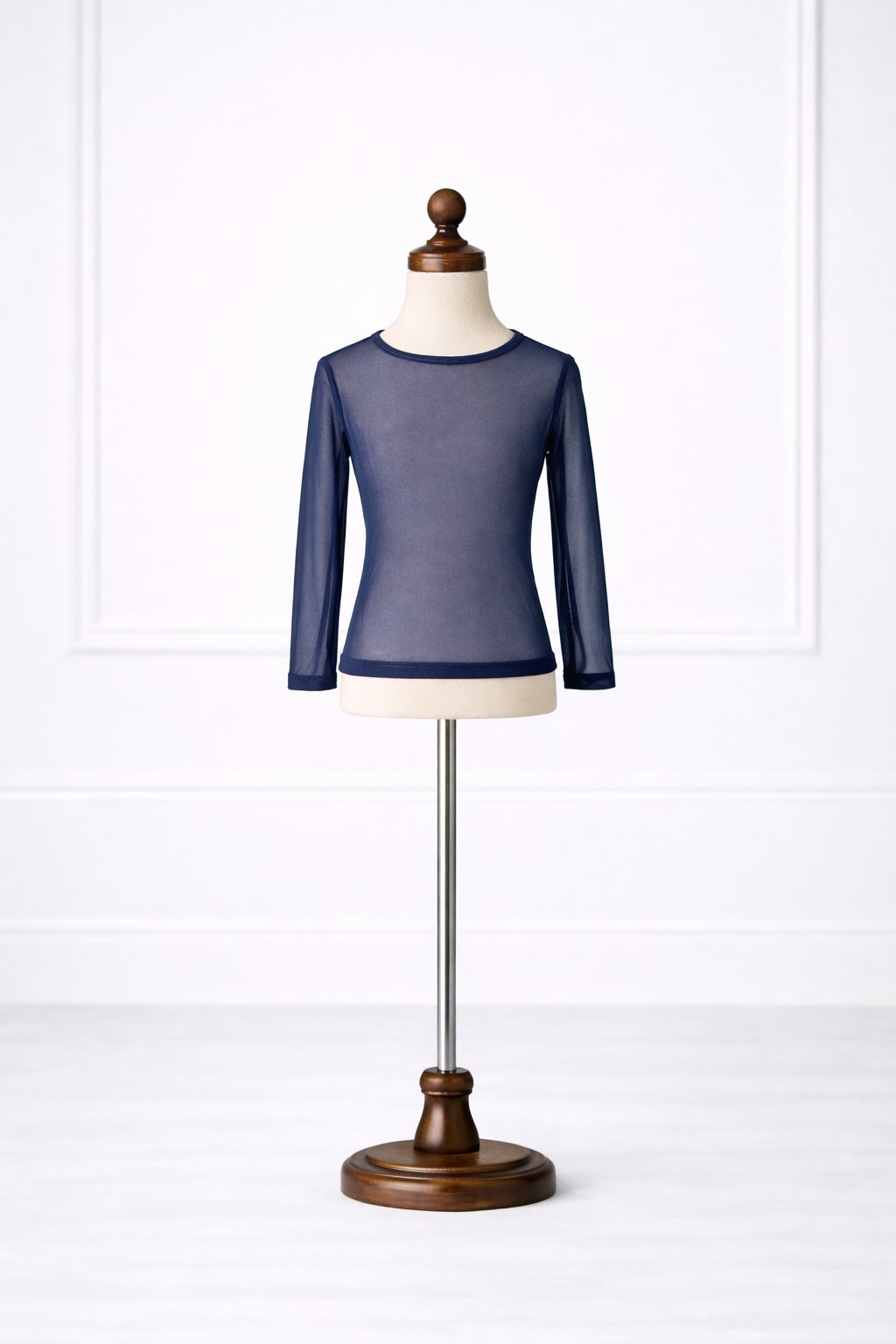 Navy blue long-sleeve top on a mannequin against a white background