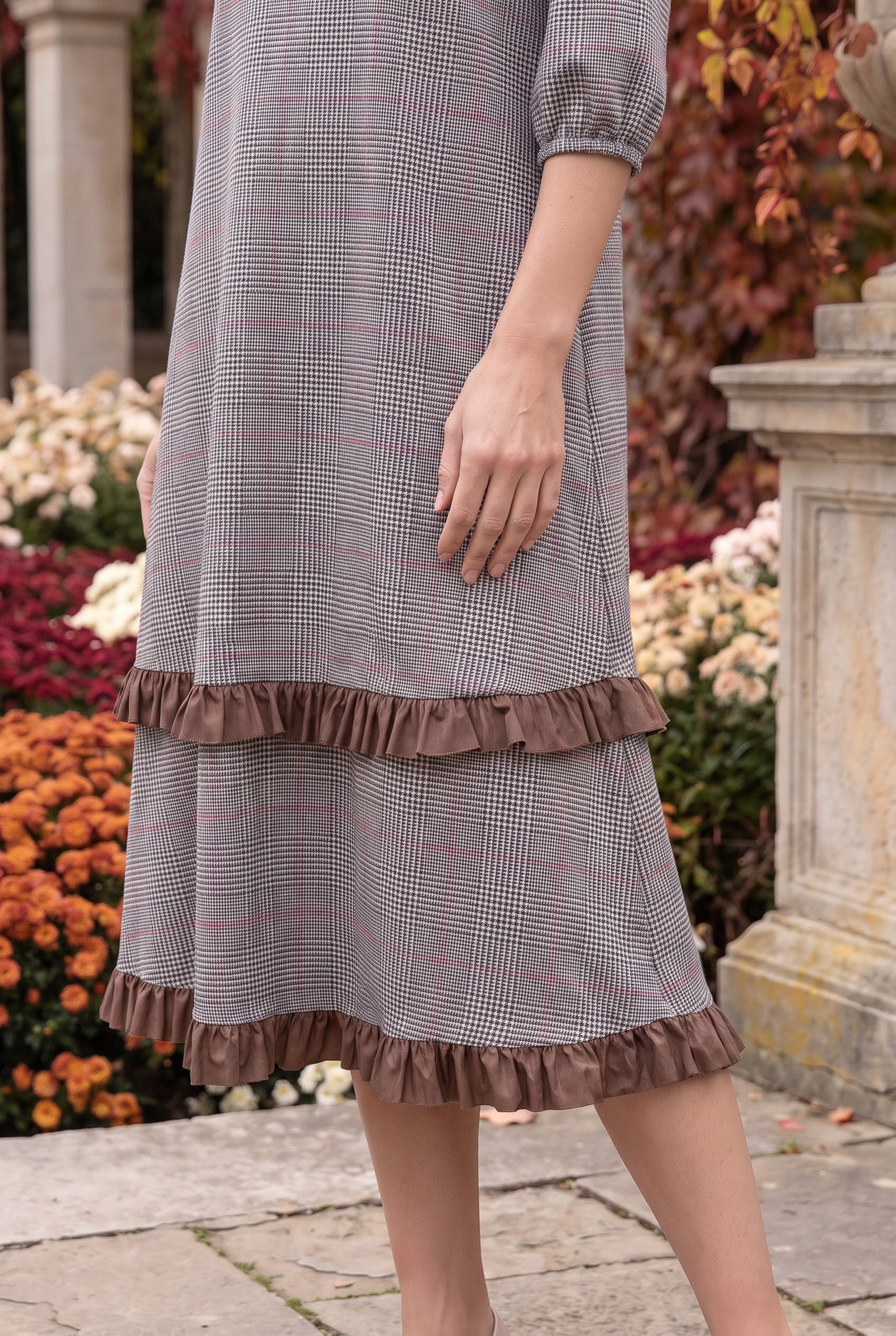 Nuggles® Patricia Dress in Glen Plaid, close crop of the tiered skirt and its two brown ruffles