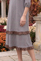 Nuggles® Patricia Dress in Glen Plaid, close crop of the tiered skirt and its two brown ruffles