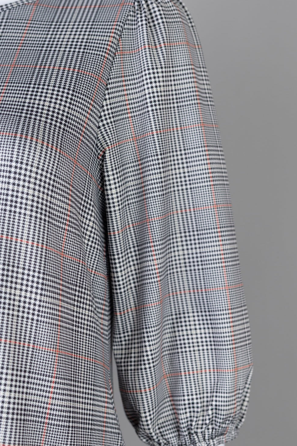 Nuggles® Patricia Dress in Glen Plaid, detail of the gray and brown glen check with brown ruffle trim