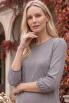 Nuggles® Patricia Dress in Glen Plaid, upper-body portrait showing the round neckline and gray check