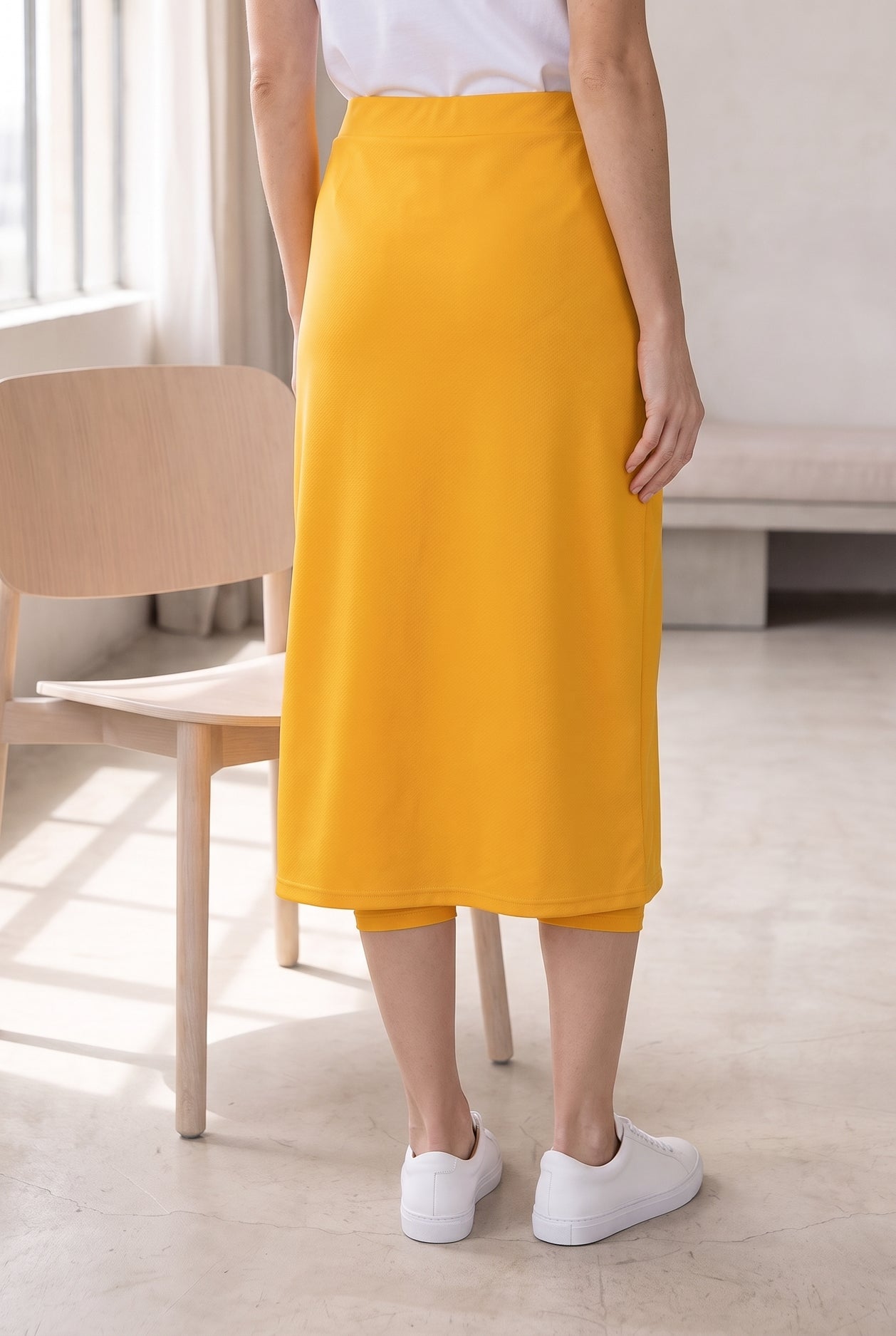 Model wearing Nuggles®  31" Sport Skirt in Gold