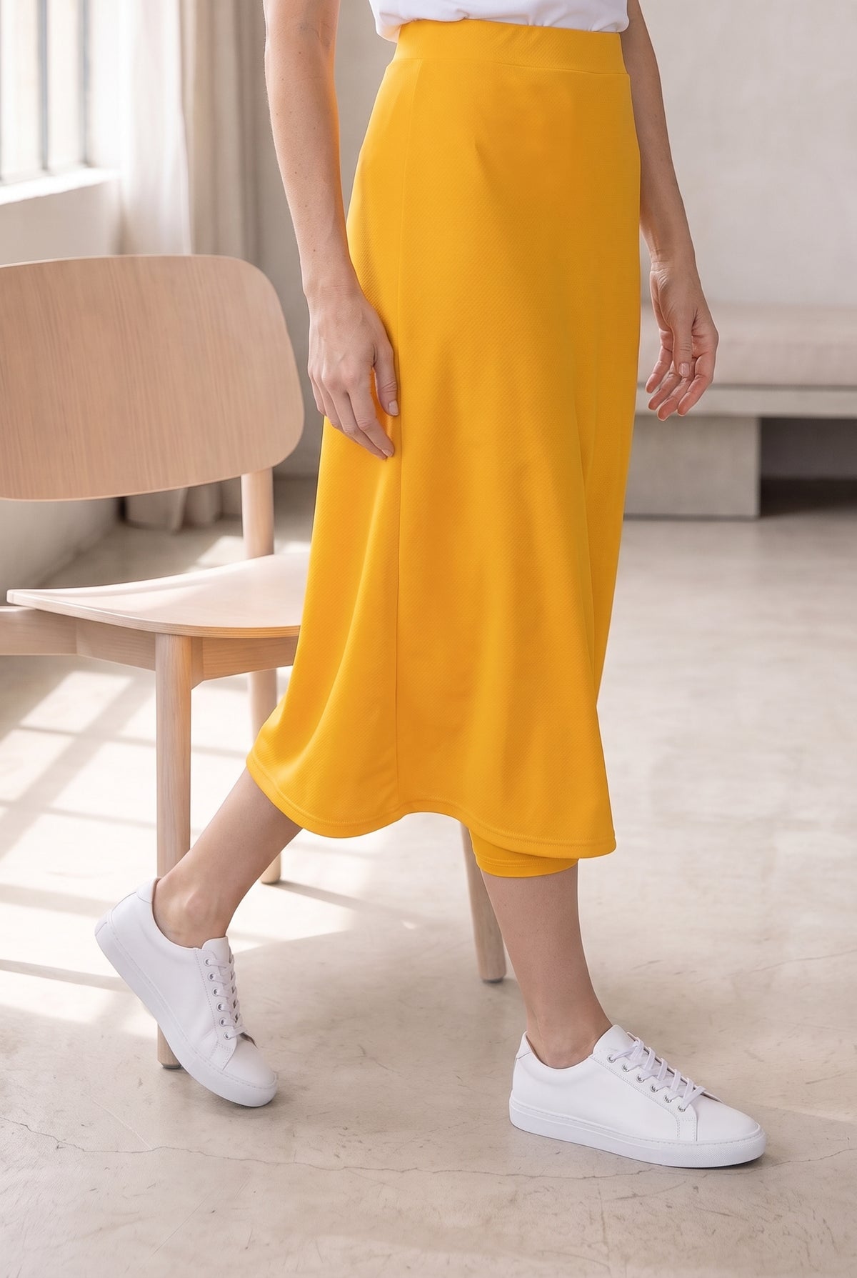 Model wearing Nuggles®  31" Sport Skirt in Gold