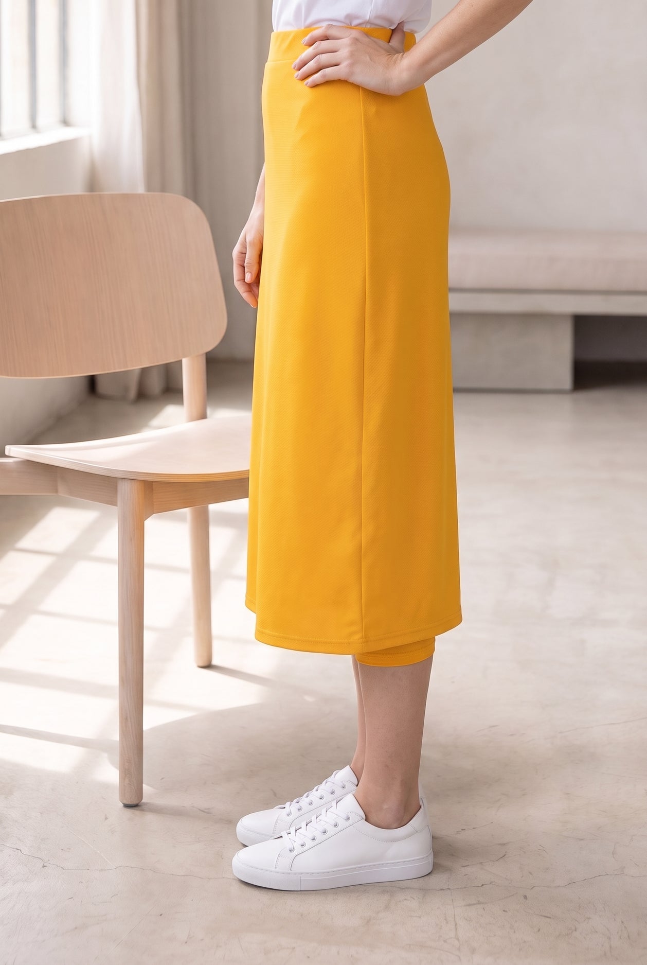 Model wearing Nuggles®  31" Sport Skirt in Gold