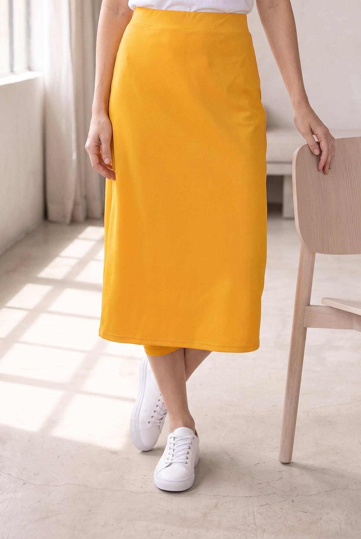 Model wearing Nuggles®  31" Sport Skirt in Gold