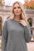 Nuggles® Oakley Hoodie Dress in Heather Gray, waist-up view with a hand at the ribbed crew neckline