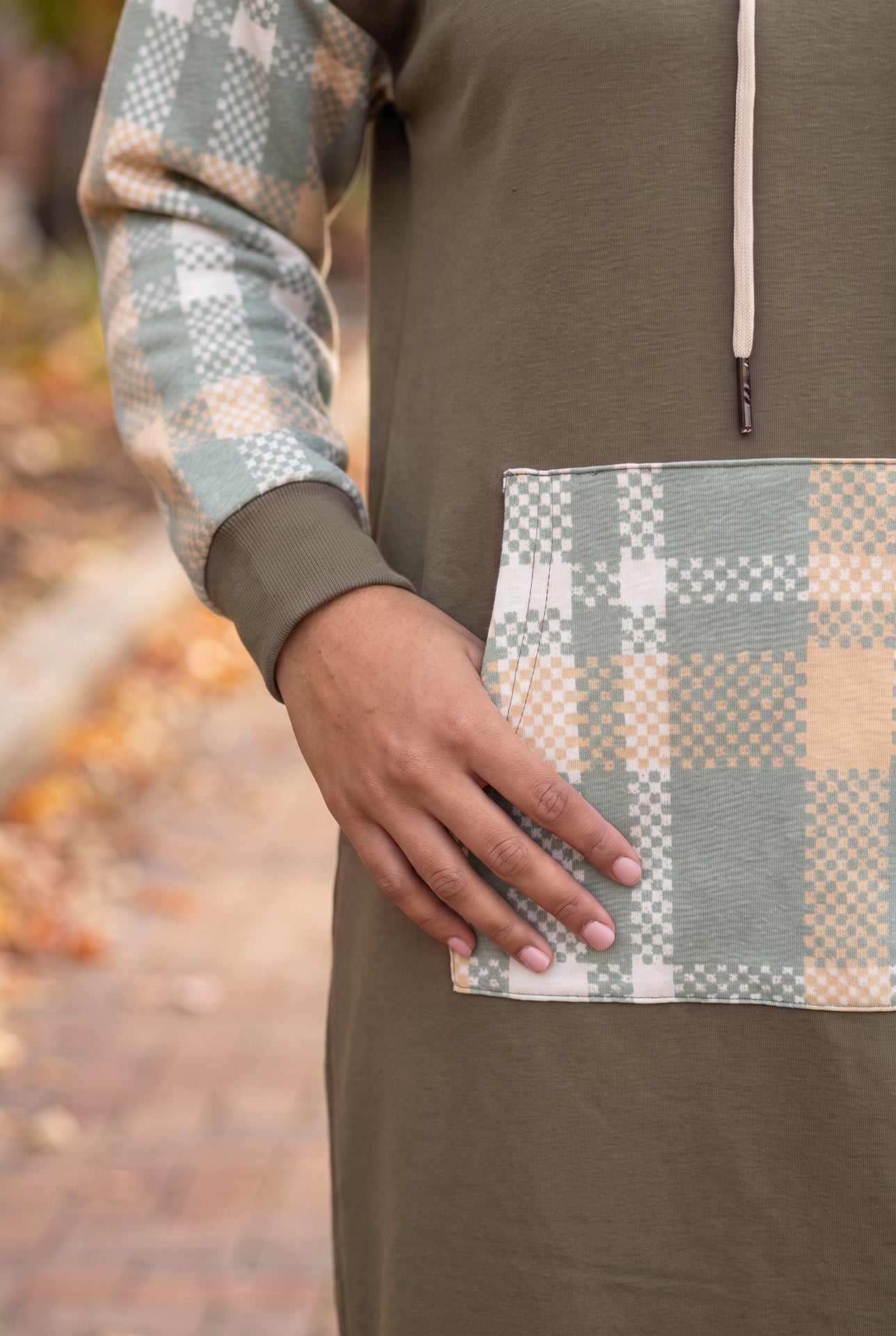 Model wearing Nuggles®  Hoodie Dress in Olive Plaid