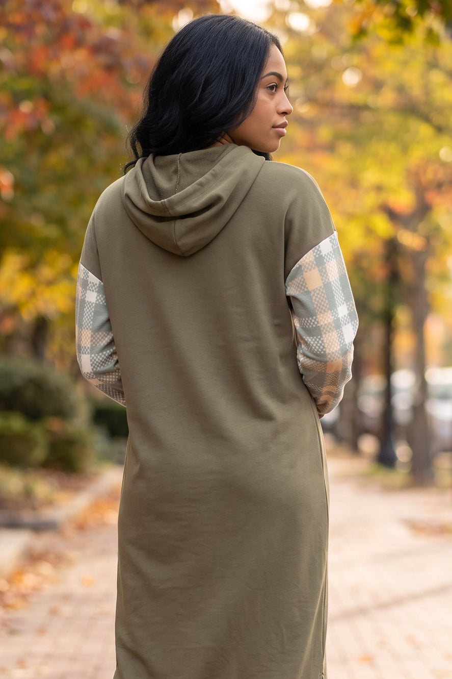 Model wearing Nuggles®  Hoodie Dress in Olive Plaid