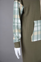 Model wearing Nuggles®  Hoodie Dress in Olive Plaid