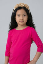 Model wearing the Girls' Nuggles® 3/4 Essential Tee in Hot Pink