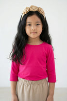 Model wearing the Girls' Nuggles® 3/4 Essential Tee in Hot Pink