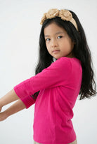 Model wearing the Girls' Nuggles® 3/4 Essential Tee in Hot Pink