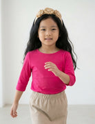 Model wearing the Girls' Nuggles® 3/4 Essential Tee in Hot Pink