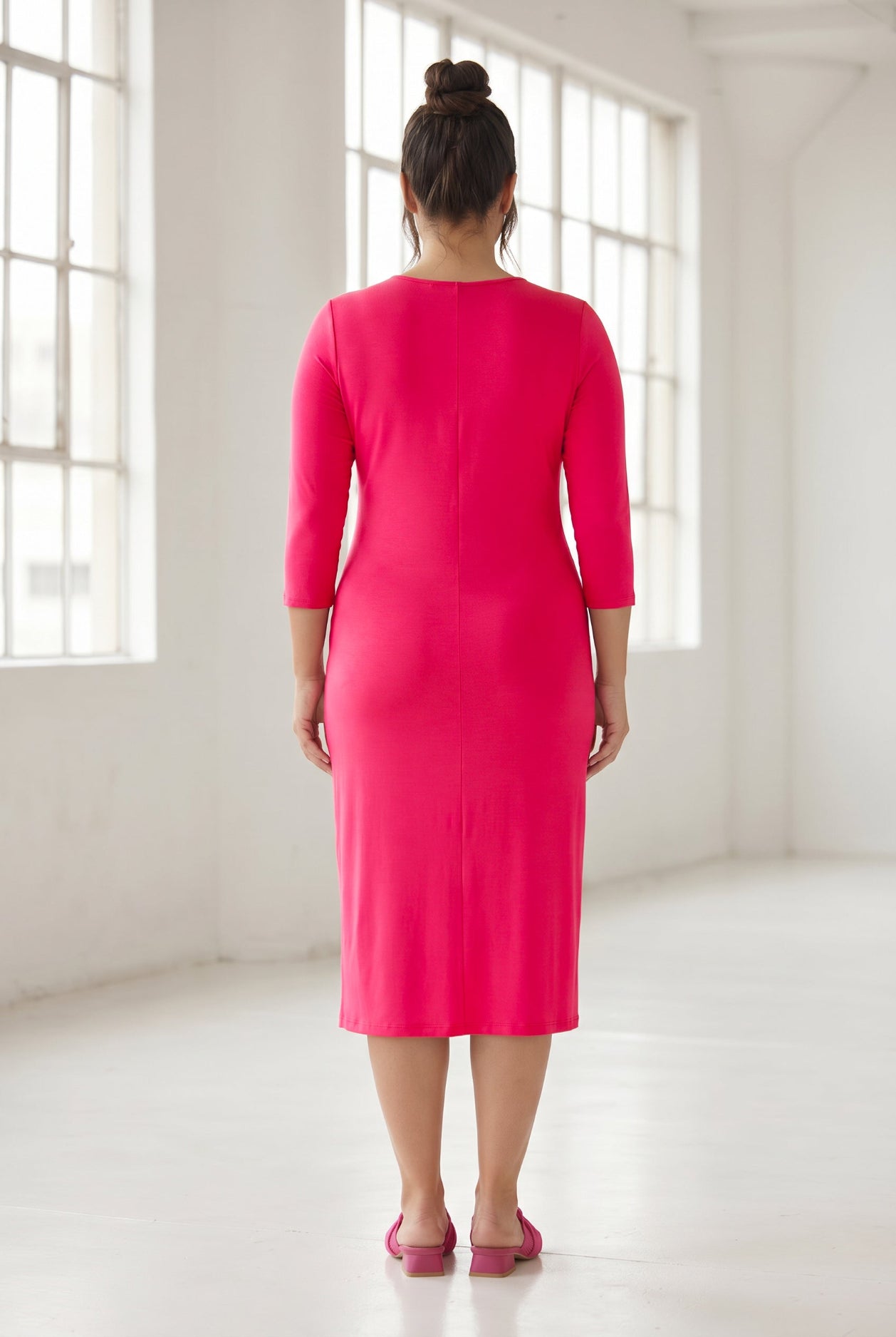 Model wearing Nuggles® Midi Layering Dress in Hot Pink