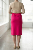 Women wearing a brick hot pink classic 27" midi length skirt with a beige shirt in a sunlight loft.