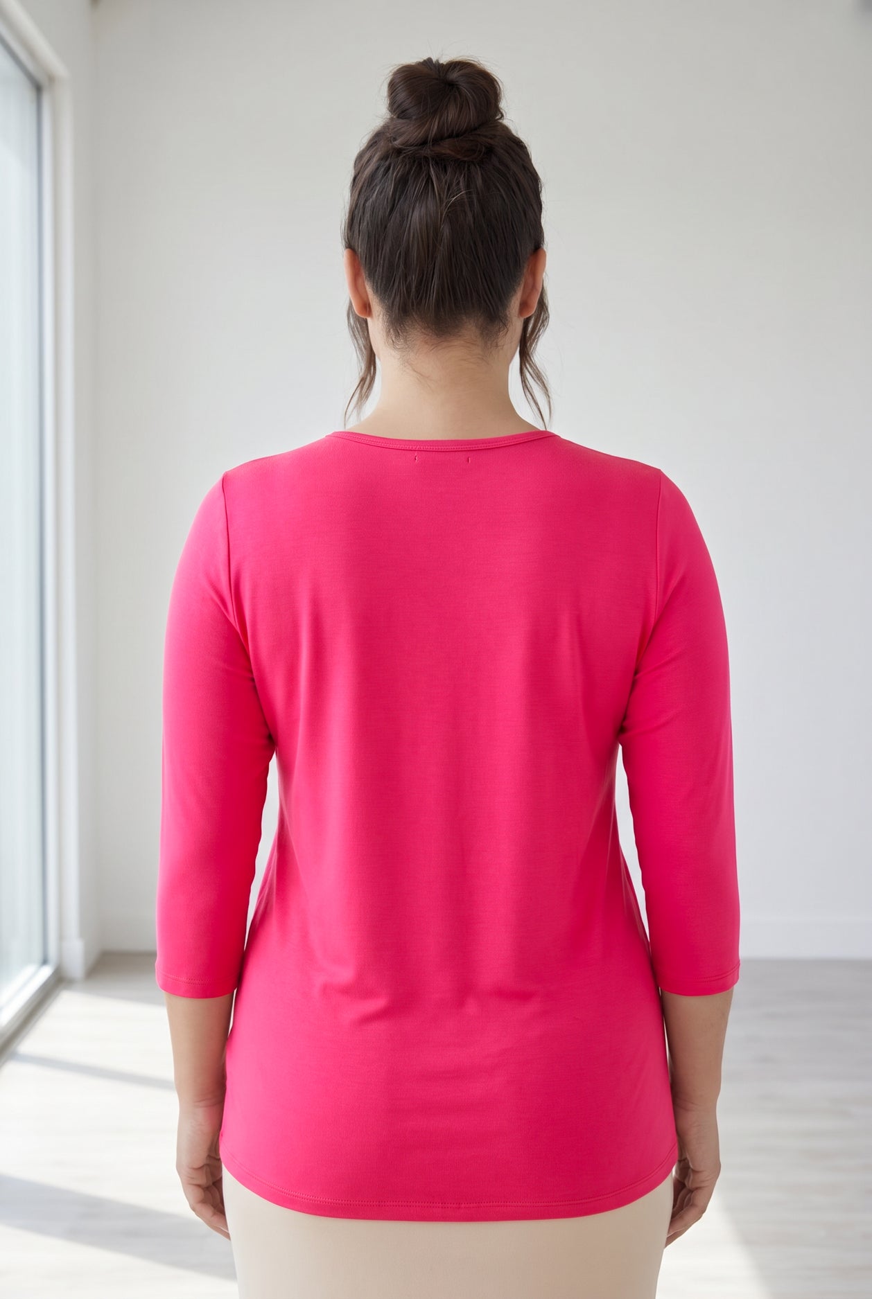 Model wearing Nuggles® 3/4 Essential Tee in Hot Pink