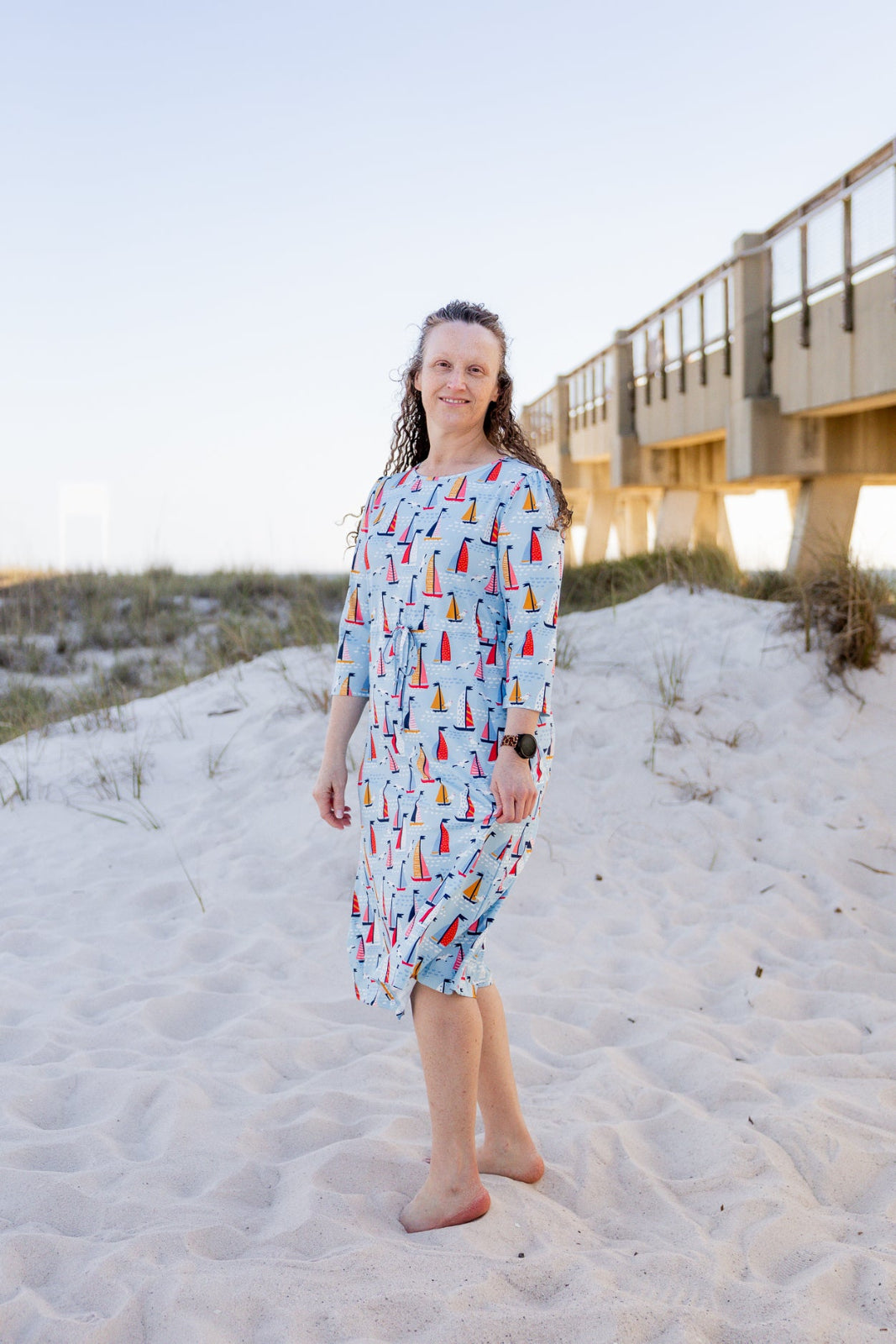 Model wearing Nuggles® Nola Sport Swim Dress in Harbor Sailboats 