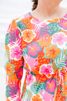Model wearing Nuggles® Nola Sport Swim Dress in Luau Garden