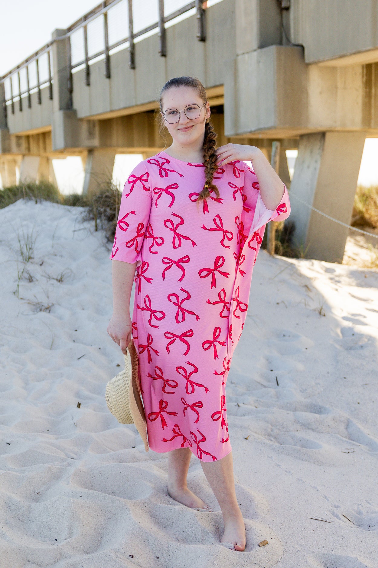 Model wearing Nuggles® Carlie Swim Dress in Pretty Bow