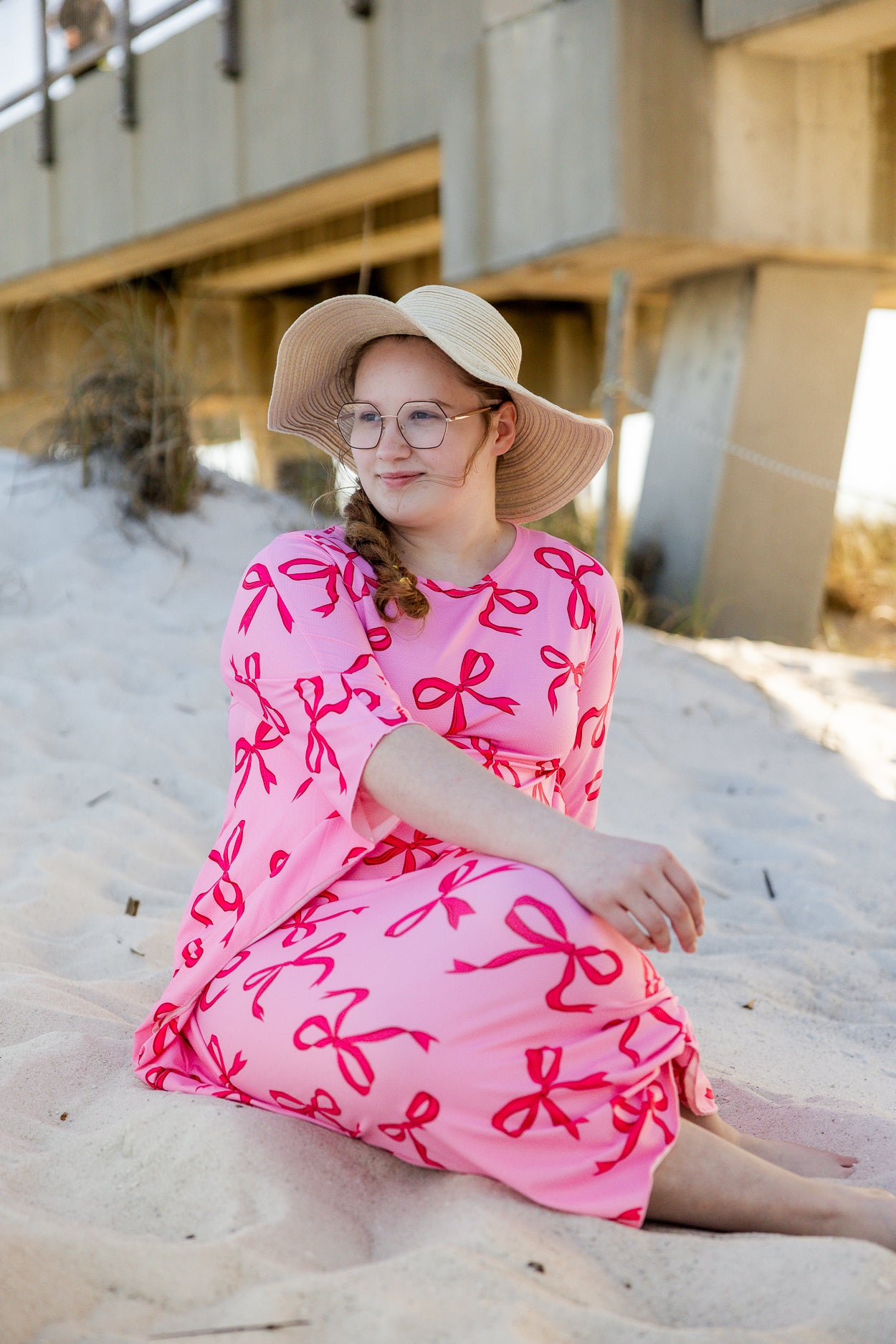 Model wearing Nuggles® Carlie Swim Dress in Pretty Bow