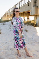Model wearing Nuggles® Sport Swim Dress in Watercolor Blossom