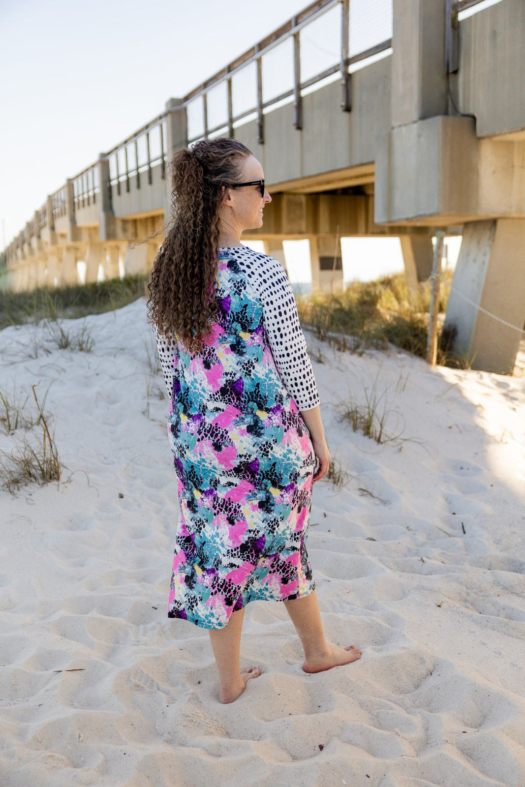 Model wearing Nuggles® Sport Swim Dress in Watercolor Blossom