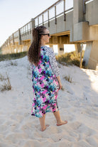 Model wearing Nuggles® Sport Swim Dress in Watercolor Blossom