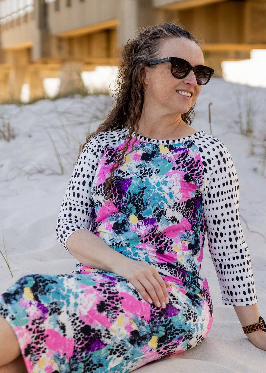 Model wearing Nuggles® Sport Swim Dress in Watercolor Blossom