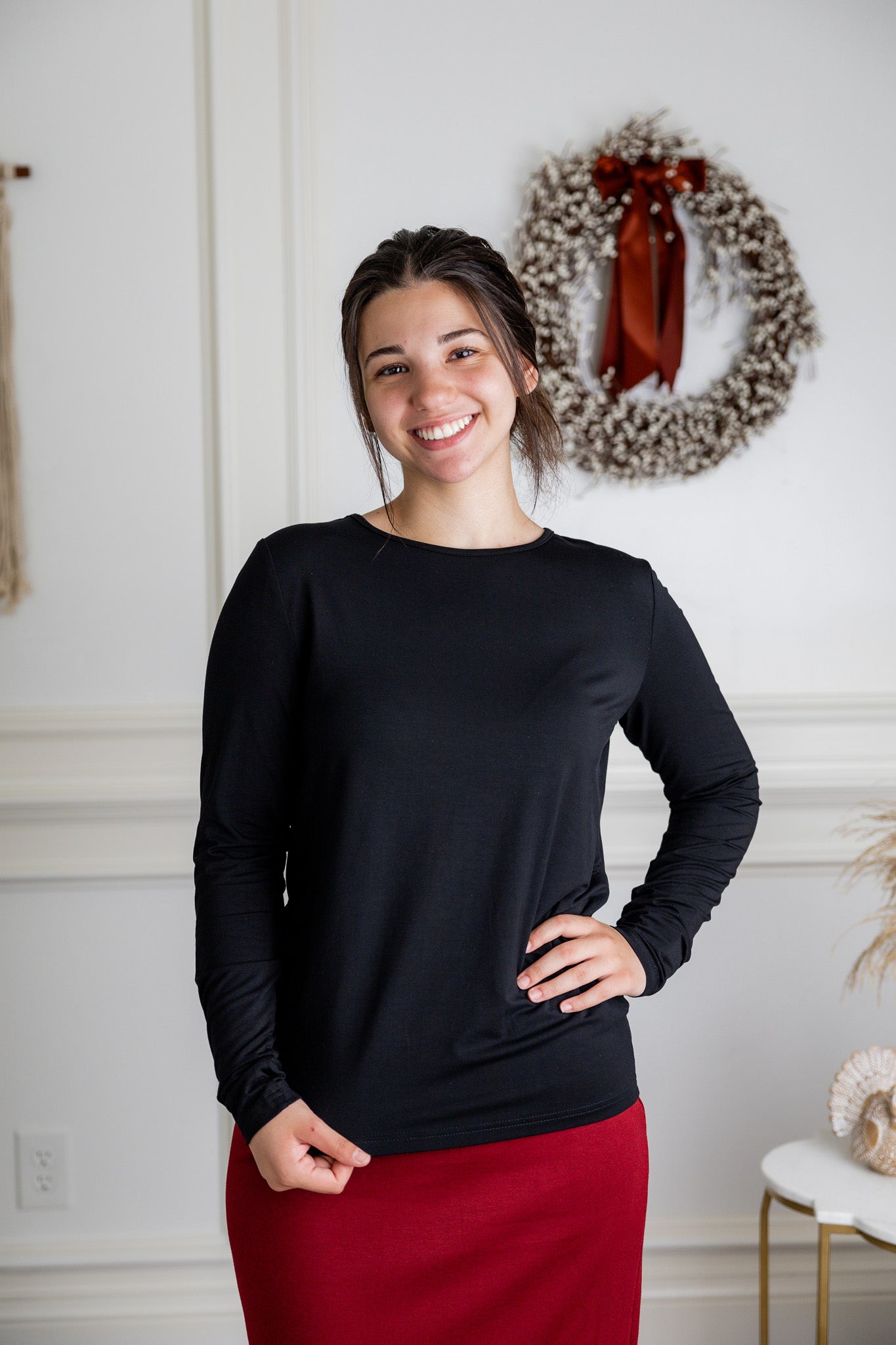 Model styling a neutral Nuggles® long sleeve top for casual everyday outfit inspiration.