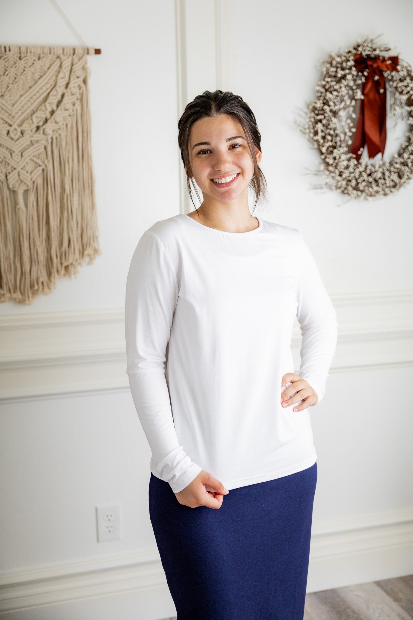 Model styling a neutral Nuggles® long sleeve top for casual everyday outfit inspiration.