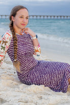 Model wearing Nuggles® Sport Swim Dress in Ribbon Scribbles